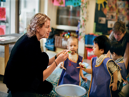 Image of a female person playing with the children