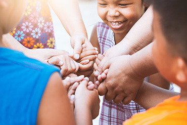 Children holding hands in a circle.