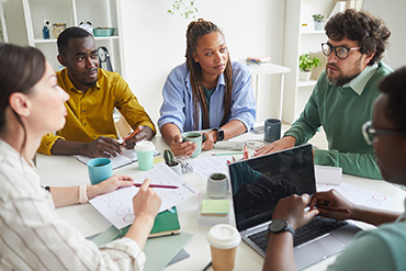 Group of people around a table having a meeting