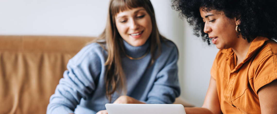 Two women looking at a screen