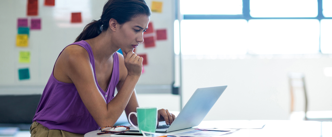 A woman looking at a computer screen.